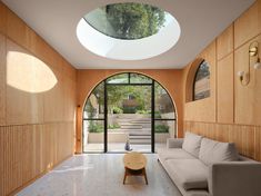 a living room filled with furniture under a skylight