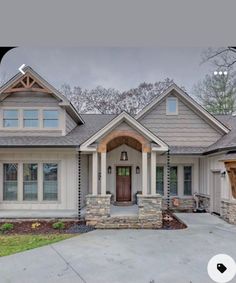 a house that is in the process of being painted white and has gray shingles