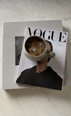 a magazine with a photo of a man holding a cup of coffee