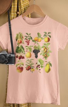 Vintage fruit collage cottagecore aesthetic design from PoohBearCo. Super-soft *UNISEX* tee with a vintage look and feel. To ensure sizing, refer to size chart in photos and compare measurements to those of a shirt you already own that fits well. Our inks are eco-friendly, nontoxic, and water-based. Solid colors: 100% Preshrunk Cotton Heather Colors: 52% Cotton / 48% Poly * Pre-shrunk * Shoulder-to-shoulder taping * Side-seamed Grape Orchard, Fruit Collage, Berry Picking, Botanical Shirt, Vintage Fruit, Cottagecore Aesthetic, Farmer's Market, Gifts For Nature Lovers, Aesthetic Design