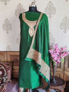 Pure Silk Tilla Kashmiri Suit With Heavy Embroidered Sleeves, This Kashmiri Premium Tilla Salwar Suits Comes in Three-Piece; Shirt , Salwar and Dupatta and is Available in Both Unstitched as well as Stitched Option. Embroidery Tilla Embroidery Suit Type Three-Piece (Shirt, Dupatta and Salwar) Color Green Fabric Pure Raw Silk Free Shipping Yes About Tilla Embroidery : Tilla embroidery is one of the most celebrated Kashmiri handicrafts, where the silver, golden or copper hues of tilla (zari) threa Pheran Designs, Kashmiri Suits, Party Wear Salwar Suits, Tilla Embroidery, Embroidery On Sleeves, Embroidered Salwar, Salwar Suits Party Wear, Suits Party Wear, Party Wear Salwar