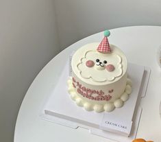 a birthday cake with a teddy bear on top sits on a table next to other desserts