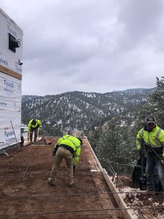 construction workers working on the roof of a building