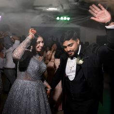 a man and woman dancing at a party