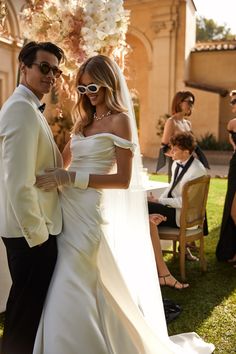 a bride and groom standing next to each other in front of an outdoor wedding ceremony