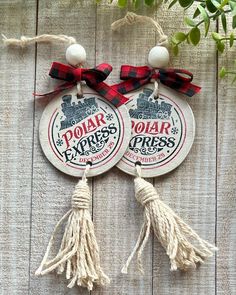 two wooden plaques with tassels hanging from them