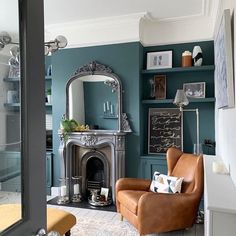 a living room filled with furniture and a fire place in front of a mirror on the wall