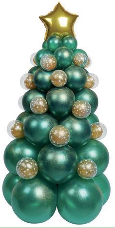 a christmas tree made out of green balls and gold stars on it's top