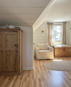 a living room with wood floors and white walls