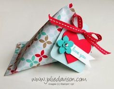 two folded gift bags with red and blue paper on them, one is shaped like a heart