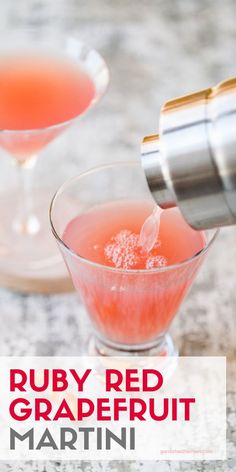 a red grapefruit martini is being poured into a coupe glass and garnished with sugar