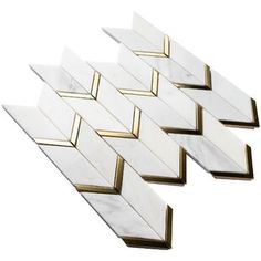 four white and gold chevroned marble tiles with brass trims on each side