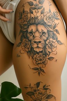 a woman's thigh with a lion and roses tattoo on the bottom half of her leg