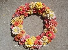 a wreath made out of fake flowers on the ground