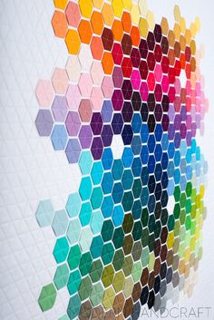 a multicolored hexagonal pattern on a white wall