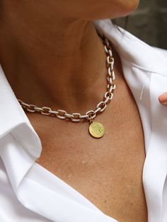 The white enamel on the gold chain necklace adds a sleek and elegant touch, while the stainless steel base provides durability. The round gold engraved love sign charm enhances the overall design, combining sophistication with sentiment. Chain is made of stainless steel, gold ION plated with 18k gold. This necklace effortlessly elevates any ensemble, making a bold yet refined statement. Elegant and stylish, it's a versatile accessory that complements both formal and trendy attire, adding a touch White Tarnish Resistant Necklace With Initial Pendant, White Tarnish Resistant Initial Pendant Necklace, White Tarnish-resistant Initial Pendant Necklace, White Tarnish Resistant Metal Necklace, White Adjustable Chain Necklace, White Enamel Round Pendant Jewelry, Personalized White Round Charm Necklaces, Personalized White Pendant Charm Necklace, Personalized White Enamel Jewelry