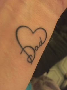 a heart shaped tattoo with the word dad on it