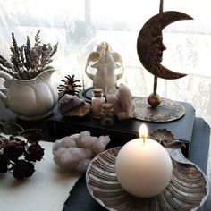 a candle is sitting on a table with other items