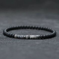 Step into the realm of cool, chic style with the Sultan Minimaliste Stone Men's Bracelet from EFFENTII! This is not just an accessory, it's a reflection of who you are - bold yet sophisticated. It subtly whispers to the world that you're a man who appreciates quality and isn't afraid to showcase his unique charm.Crafted meticulously using natural stone beads, this slim minimalist beaded bracelet offers undeniable durability and timeless elegance. The jet black onyx base is elevated by accent sto Masculine Everyday Adjustable Bracelets, Modern Bracelets For Father's Day, Minimalist Black Bracelet, Adjustable Masculine Stainless Steel Bracelets, Masculine Adjustable Stainless Steel Bracelets, Masculine Adjustable Stainless Steel Bracelet, Sea Jewelry, Bracelets With Meaning, Obsidian Stone