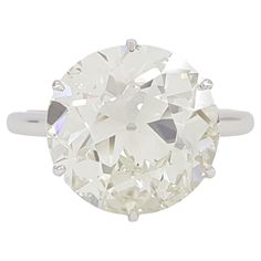 an oval cut diamond ring on a white background