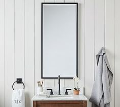 a bathroom vanity with a mirror and towel on it