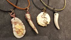 three necklaces with different designs on them