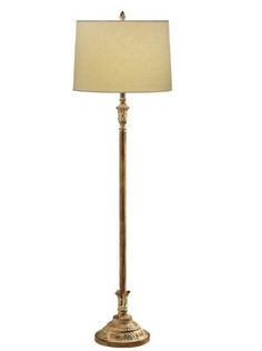 a lamp that is on top of a white table cloth and has a beige shade