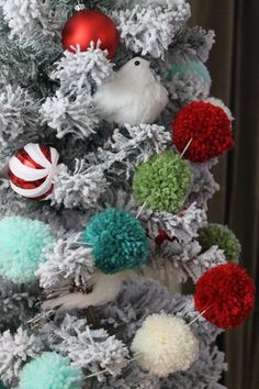 a christmas tree decorated with pom poms and ornaments