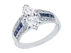 an oval cut diamond and blue sapphire engagement ring