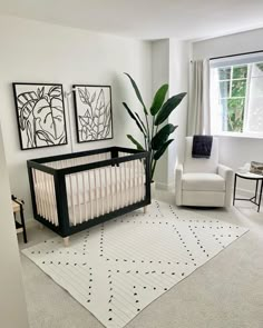 a baby's room with a crib, rocking chair and pictures on the wall