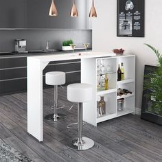 a white kitchen with two bar stools next to it