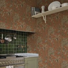 a kitchen with an oven, stove and wallpaper in it's center area