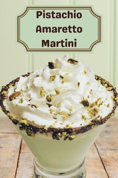 pistachio amarretto martini in a glass with whipped cream and pistachio on top