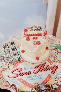 a white cake sitting on top of a table next to a sign that says save things