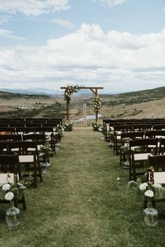 an outdoor ceremony set up with chairs and flowers