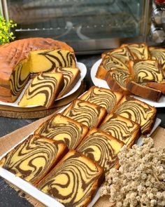 slices of cake sitting on plates next to other desserts