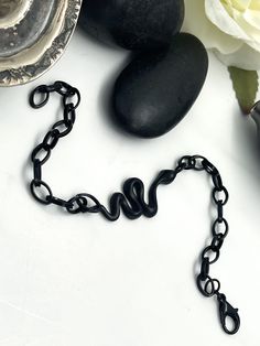 "Matt black snake link chain bracelet, minimal dark chain animal cuff bracelet, rock style simple chain bracelet, snake jewelry, gift for her Welcome to my shop! 📌Please Kindly Note: The listing is for only one bracelet!! 📌It is subjected to an anti-allergic process (nickel and lead-free). 📌It is made of black painted brass snake charm & steel chain. For BLACK PAINTED jewelry keep in mind that since a coat of paint has been carefully applied to each piece individually there may be some slight imperfections that will not affect the final look of the jewelry. 📏MEASUREMENTS: *Snake: 1.77\" (4.5cm) x 0.59\" (4.5cm) *Link Chain: 5mm All jewelry can be adjusted to any size and custom-made for you free of charge.* Matching Earrings: https://anangelshug.etsy.com/listing/1620222070 Matching Nec Minimalist Black Metal Chain Bracelet, Minimalist Black Chain Bracelets, Black Metal Snake-shaped Jewelry, Minimalist Black Snake Chain Jewelry, Minimalist Black Chain Bracelet, Bracelet Minimal, Jewelry Measurements, Paint Brass, Simple Chain