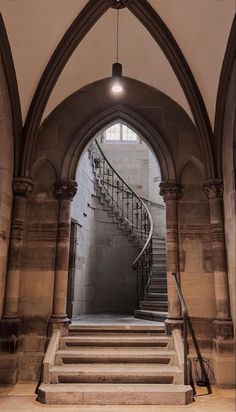 an arched doorway with stairs leading up to the second floor and another set of steps