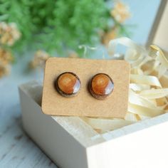 Woodland studs earrings, Simple ear studs, Tree branch earring, Round wood studs, Unique gift for nature lover. These NATURAL WOODEN ear studs are made from a fallen tree branch. I cut it into slices, sanded and covered with a drop of resin. Posts are STERLING SILVER. I will send these earrings in a solid GIFT BOX, carefully packed in brown paper and tied with linen cord. Earrings are ready for shipping. 3 similar pairs available. Nature is beautiful!  WOOD DIMENSIONS: - 11 mm 0.43 inch diameter Nature-inspired Natural Wood Earrings For Gift, Nature-inspired Natural Wood Earrings As Gift, Handmade Natural Wood Earrings As Gift, Handmade Natural Wood Earrings For Gift, Minimalist Brown Earrings As Gift, Minimalist Brown Earrings For Gift, Round Earrings As Gift, Cord Earrings, Ocean Earrings