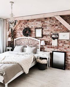 a bedroom with brick walls and white furniture