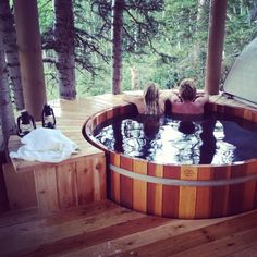 two people in a hot tub on a deck