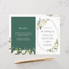 a green and white floral wedding card with gold foil lettering on the front, along with an envelope that says thank you