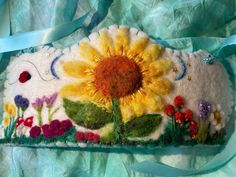 a handbag with a sunflower and flowers on it