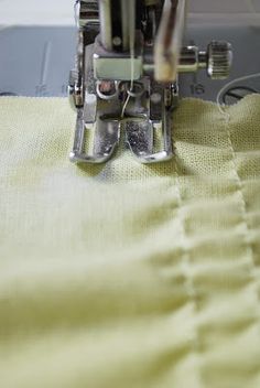 the sewing machine is working on the yellow material that has been stitched into it