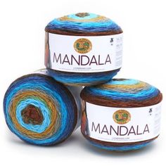 three balls of yarn with the words mandala written on them in white and blue