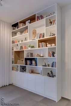 a white book shelf filled with lots of books