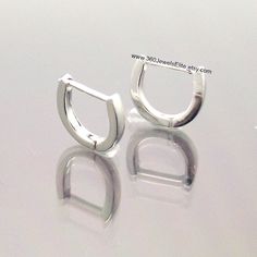 "These men's hoops earrings are a great alternative to a standard round hoop earrings. These curved earrings are a size M and have a length of 9mm. They are handmade from solid 14K white gold. Sold as a pair or as a single earring. SPECIFICATION Metal : 14K Solid White Gold Approximate width: 1.4mm Approximate thickness: 1.3mm Outer diameter: 9mm Inner diameter: 1/4\", medium Outer layer: White gold plated Ear post gauge: 20g 14K yellow gold https://www.etsy.com/listing/224984998 Thanks for view Modern Hypoallergenic White Gold Huggie Earrings, Modern White Gold Small Hoop Huggie Earrings, Curved Earrings, Men's Earrings, Mens Earrings Hoop, White Gold Hoops, Earrings Hoops, Hoops Earrings, Men Earrings