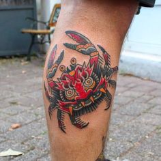 a close up of a person's leg with tattoos on it and a crab