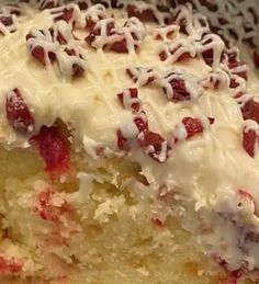 a piece of cake with white frosting and cranberries on top is shown