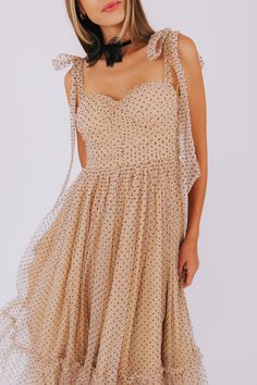 Dazzle in this champagne colored dress with a tulle overlay and playful black polkadots. Featuring a sweetheart neckline, ruching on the bodice, and a smocked panel on the back for the perfect fit. Complete with a silver zipper in the back and a tiered skirt, this midi dress is sure to turn heads. Adjustable tie straps add a fun touch. Details Champagne colored dress Tulle overlay Black polkadots Sweetheart neckline Ruching on bodice Padded cups Smocked panel on back Silver zipper in back Tier o Champagne Colored Dress, Champagne Color Dress, Stars Dress, Mesh Bows, Chocker Necklace, Dress Tulle, Silver Zipper, Star Dress, Necklace Black